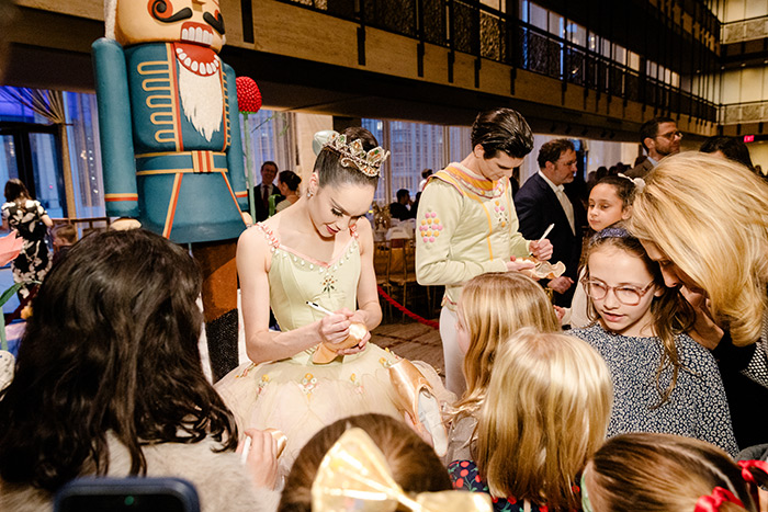 NYCB Principal Dancer Mira Nadon signing autographs for young guests