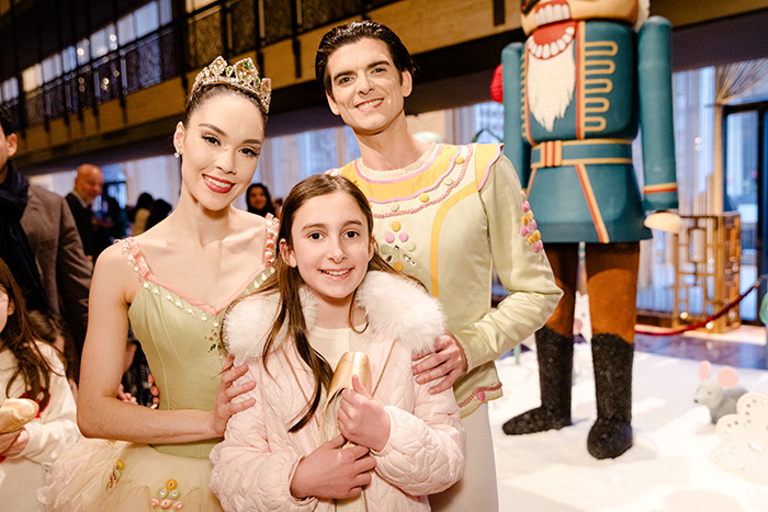 NYCB Principal Dancers Mira Nadon and Peter Walker with a young guest