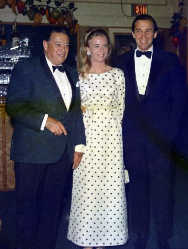 Morton Downey with stepdaughter and son-in-law William Edward Cook and Catherine Hohenlohe at the Coconuts' New Year's Eve party in Palm Beach. Bert Morgan collection. Photographed on December 31, 1967.